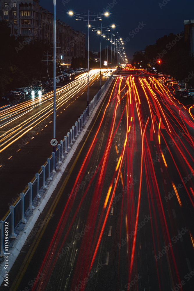 Obraz premium Blurred car traffic light at night city. Traffic jam in evening rush hour.