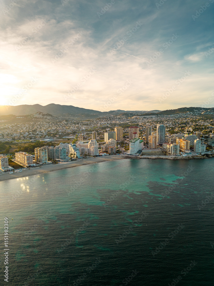 Naklejka premium Spectacular coastline of Calpe at sunset. Beautiful panoramic view of all region. Luxury urbanisations and Hotels. Famous travel destination in Alicante, Costa Blanca, Spain. Sunset point.