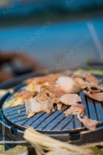 Roasted pork with vegetables on a hot electric stove. Thai called Mu Kratha. Thai barbecue style. photo