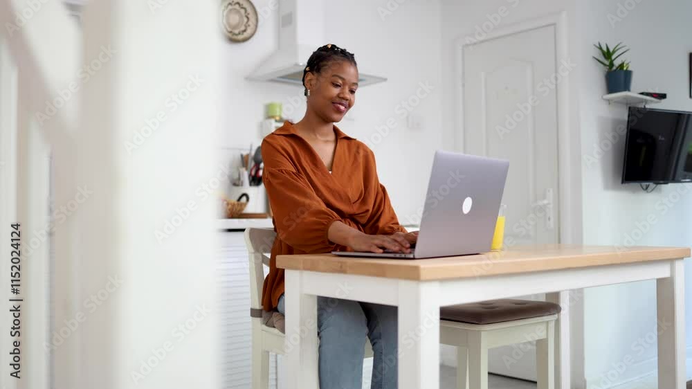 Young African American woman working online from her home office Young African American woman working online from her home office