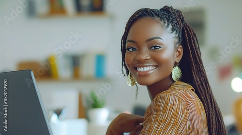 Young African Woman Smiling Warmly While Working Diligently at Desk photo