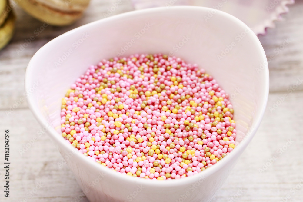 Bowl of pink sprinkles to decorate biscuits and cupcakes.