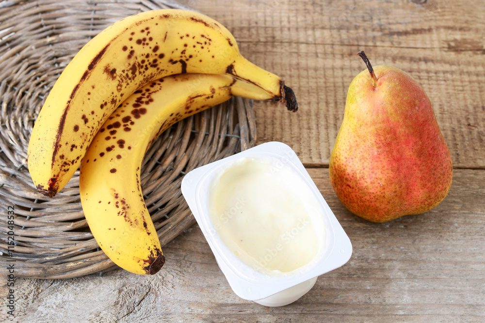 A box of natural yogurt with pear and banana.