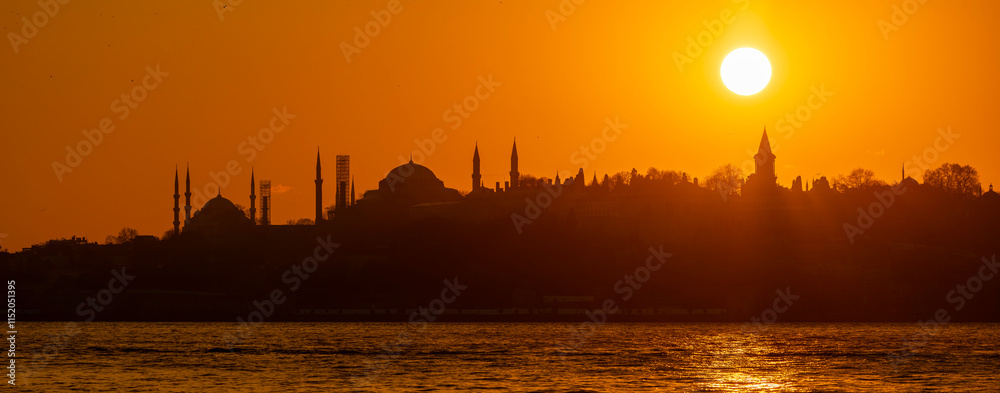 Eminonu city with mosque silhouettes in the background at sunset