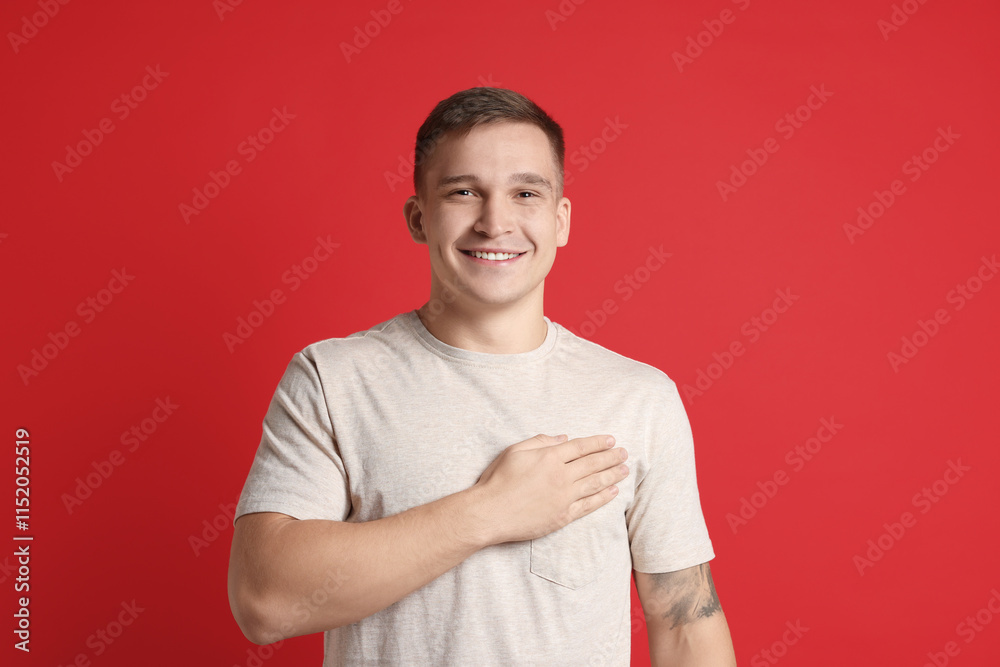 Man making promise on red background. Oath gesture Man making promise on red background. Oath gesture