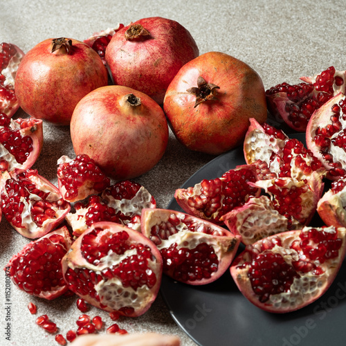 Ripe pomegranates, peeled and whole, the concept of benefits and vitamins in fruit. photo