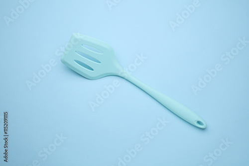 Silicone kitchen spatula on a blue background photo