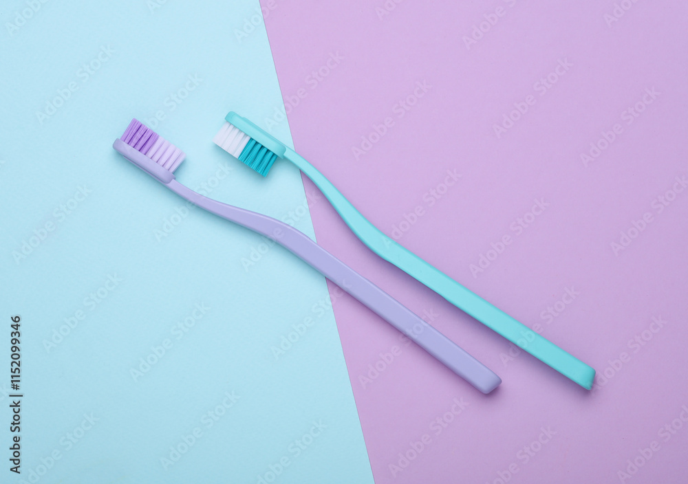Plastic toothbrushes on a pastel background Plastic toothbrushes on a pastel background