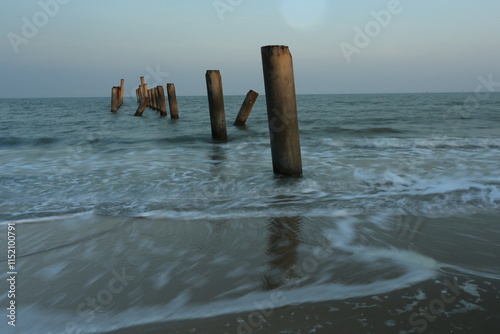 Inclined Column Beach, scenery view of the concrete columns from the old port with beautiful sky on Sao Iang Beach at Phetchaburi province,Thailand photo