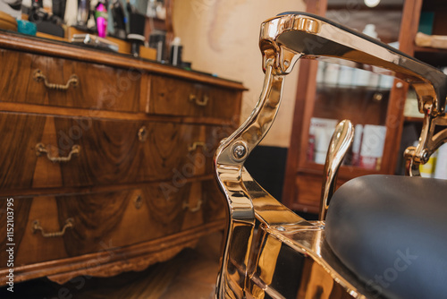 A barber shop with a gold chair and a wooden dresser