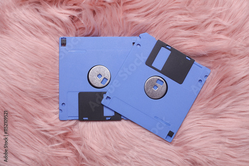 Retro 80s floppy disks on a pink fuzzy fluffy pink background