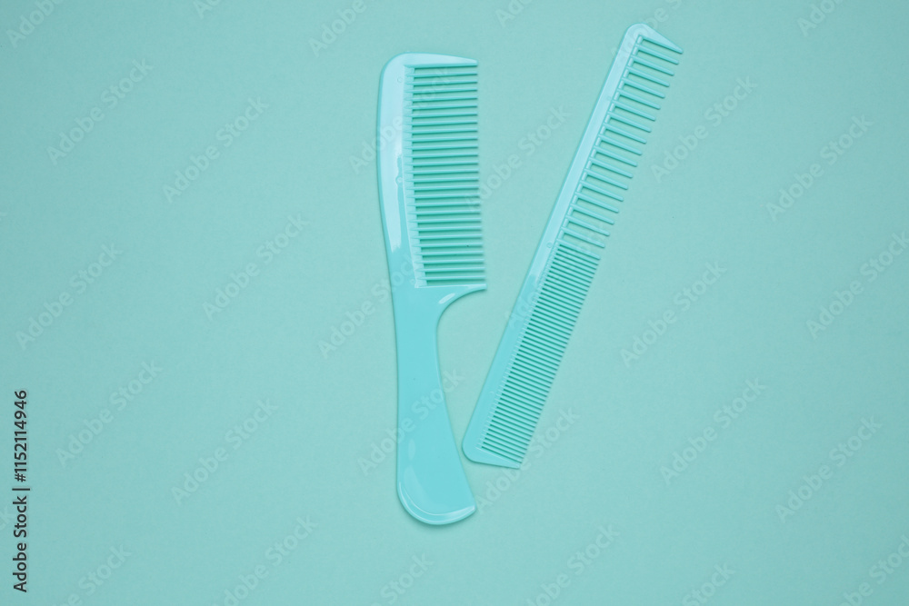 Set of plastic combs on mint green background. Top view