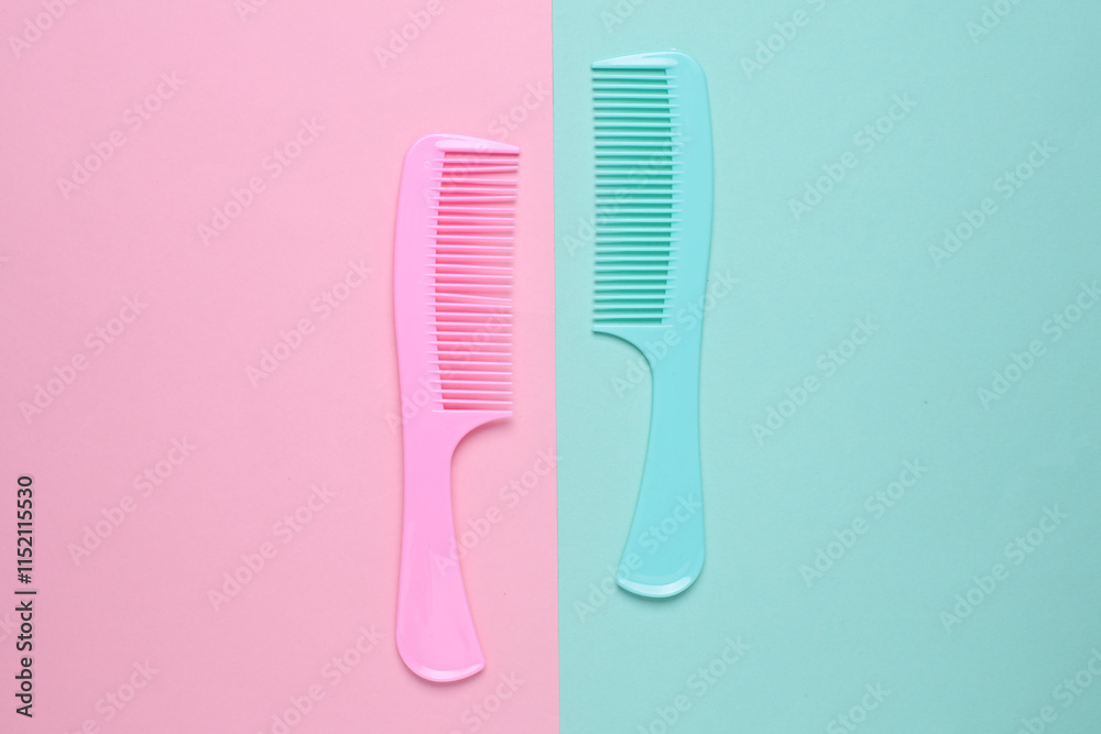 Set of plastic combs on pink blue background. Top viiew Set of plastic combs on pink blue background. Top viiew