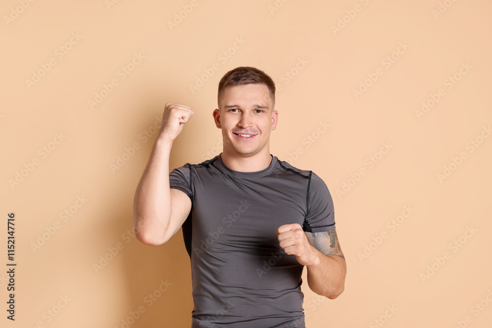 Portrait of happy winner on beige background Portrait of happy winner on beige background