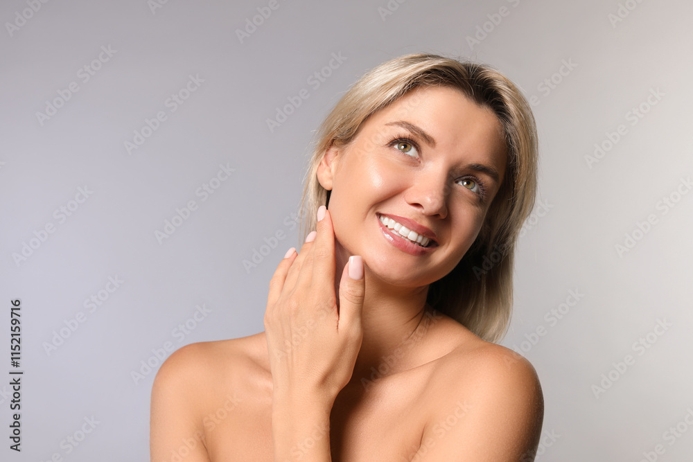 Cosmetology. Beautiful woman with perfect skin on grey background Cosmetology. Beautiful woman with perfect skin on grey background