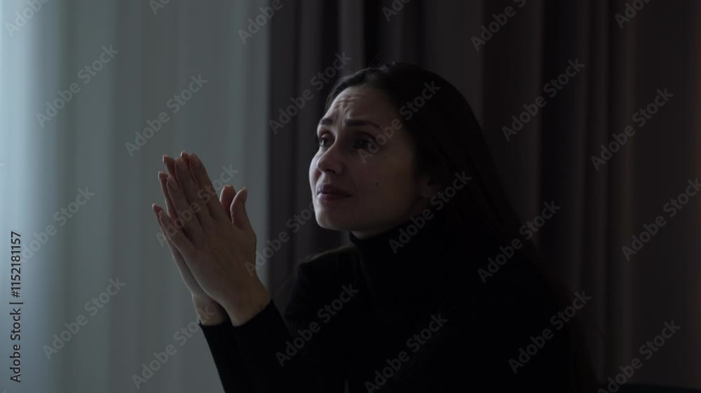 Woman suffering mental health issues, sitting at the table in front of camera, depressed expression, hopeless face, praying asking gestures, close up. Woman suffering mental health issues, sitting at the table in front of camera, depressed expression, hopeless face, praying asking gestures, close up.