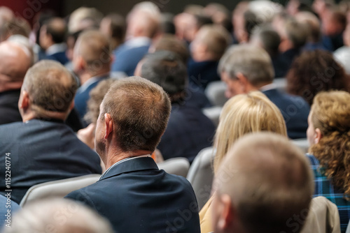 Attendees sitting in a conference room engaged in a professional business event