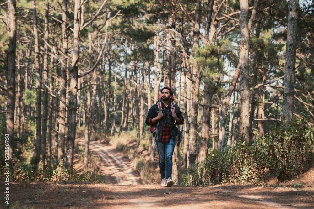 Travelers hiking through a forest with backpacks, exploring the wilderness and taking in the sights of nature as they walk. Travelers hiking through a forest with backpacks, exploring the wilderness and taking in the sights of nature as they walk.