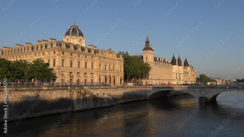 River view with small bridge in front of the Concierge Museum at sunset in Paris, France River view with small bridge in front of the Concierge Museum at sunset in Paris, France