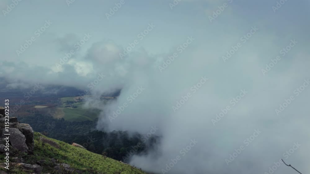 timelapse of the fog covering a green mountainous landscape in the morning from South Africa