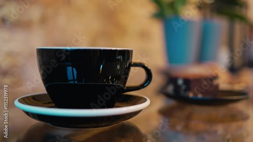 Wallpaper Mural An Elegant Black Coffee Cup placed on a Saucer accompanied by a Delicious Pastry in a Stylish Cafe Setting Torontodigital.ca