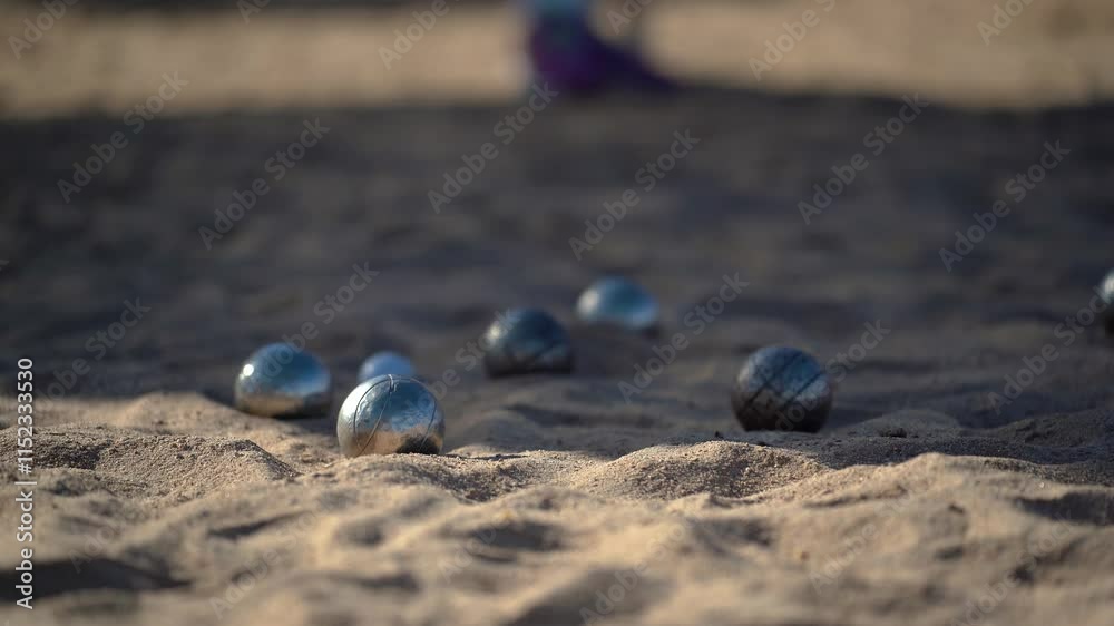 Metal balls knocking each other out in a game of petanque Metal balls knocking each other out in a game of petanque