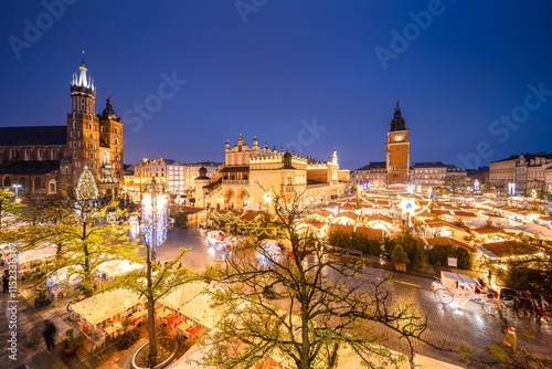 View of the Krakow Christmas Market 2024 and the historic Old Town Square, beautifully illuminated with festive lights and vibrant holiday atmosphere. photo