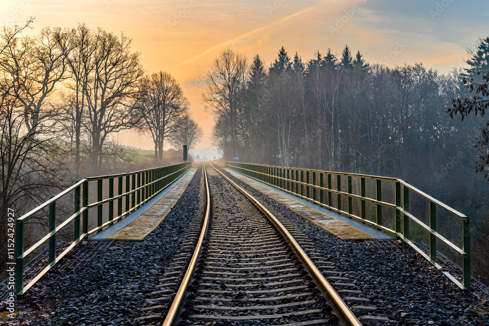 Fototapeta premium Chýnov Bridge at sunrise in the morning fog. Granite viaduct built in the village of Chýnov in South Bohemia