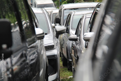 Front cut-out view of a long queue of cars lined up during a busy morning commute. Captures urban traffic congestion and daily routines, ideal for transportation and city life themes photo