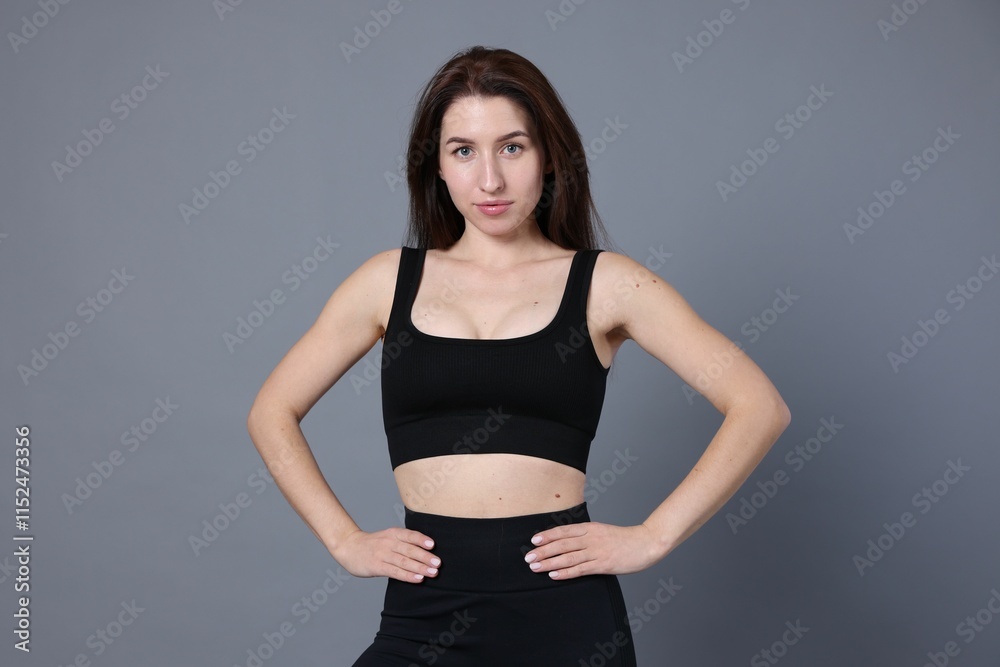 Portrait of woman in sportswear on grey background Portrait of woman in sportswear on grey background