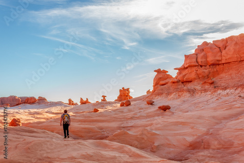 Man hiking among red rock formations in Goblin Valley State Park in Utah. photo