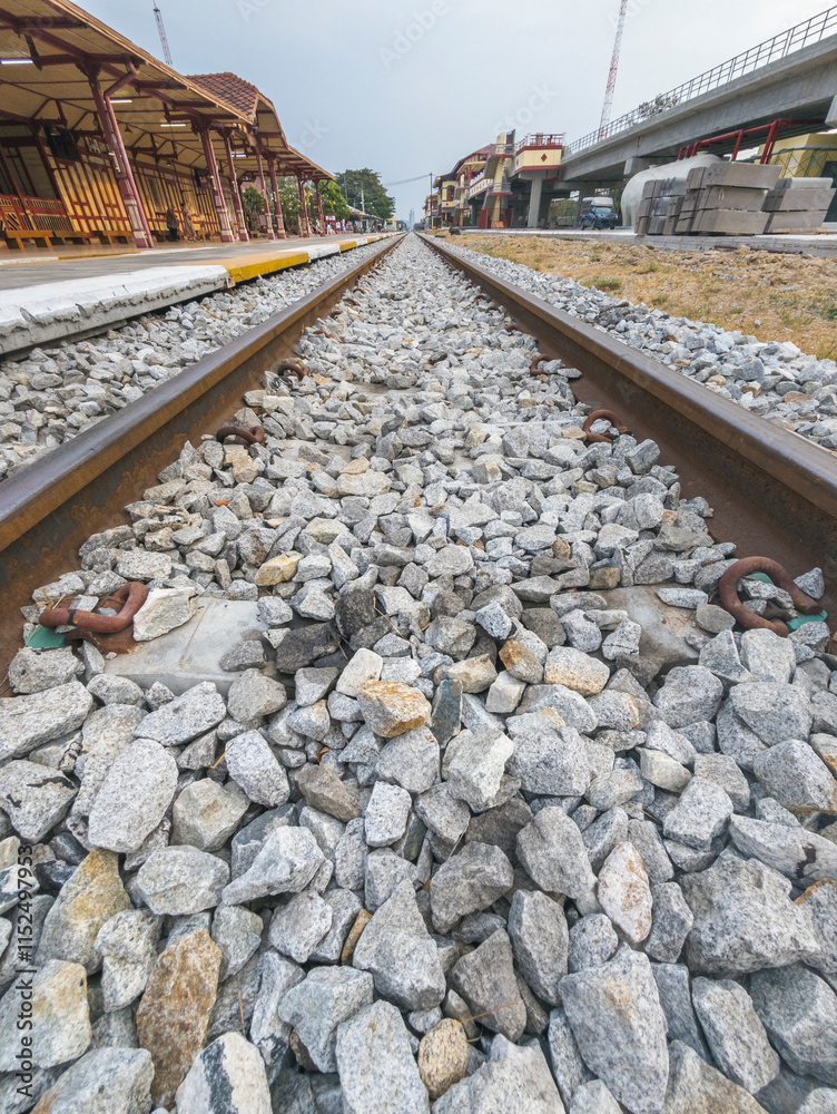 Naklejka premium Close up of Railway tracks and stone ballast,Hua Hin railway station,Thailand.