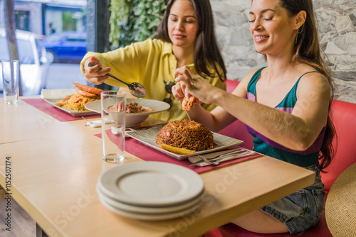 Women eating traditional ecuadorian food in madrid restaurant photo