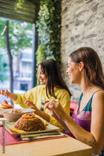 Women enjoying traditional ecuadorian meal in madrid restaurant photo