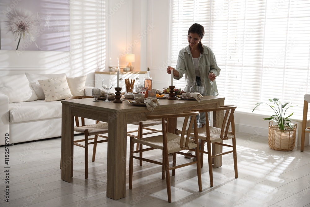 Woman setting table for dinner at home Woman setting table for dinner at home