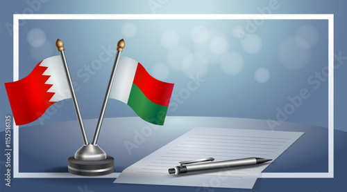 Bahrain and Madagascar National flags on small table with bokeh background, cooperative relationship