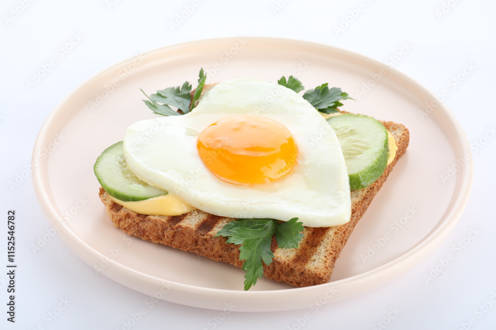 Plate of tasty sandwich with heart shaped fried egg isolated on white Plate of tasty sandwich with heart shaped fried egg isolated on white