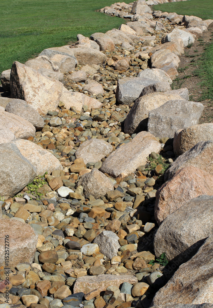 Dry streambed creek bed lined with large rocks Dry streambed creek bed lined with large rocks
