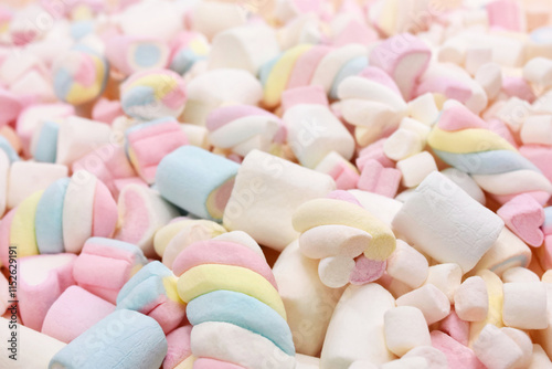 Confectionery and sweeties varieties background: light pink and white marshmallows, sugar confetti, bonbon and candies, selective focus, shallow focus photo