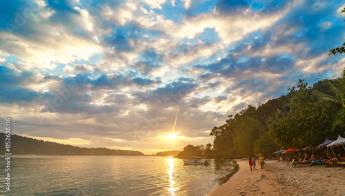 People walking on Khlong Kloi beach in Bang Bao photo