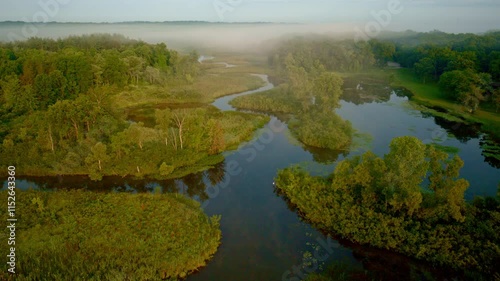 Aerial shot of the Huron River blanketed in fog at dawn, taken near Milford, Michigan. photo