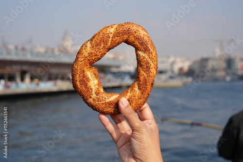 Photography women holding a Turkish Bagel Simit against istanbul city background