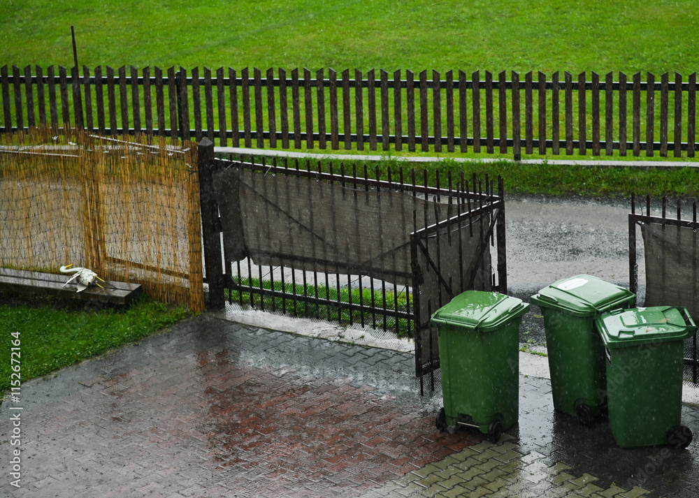 plastic garbage cans are wet from the rain plastic garbage cans are wet from the rain