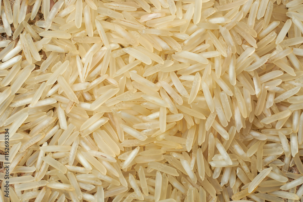 close-up macro view of raw basmati rice grains, pile of creamy white color grainy background in full frame, food wallpaper or backdrop close-up macro view of raw basmati rice grains, pile of creamy white color grainy background in full frame, food wallpaper or backdrop