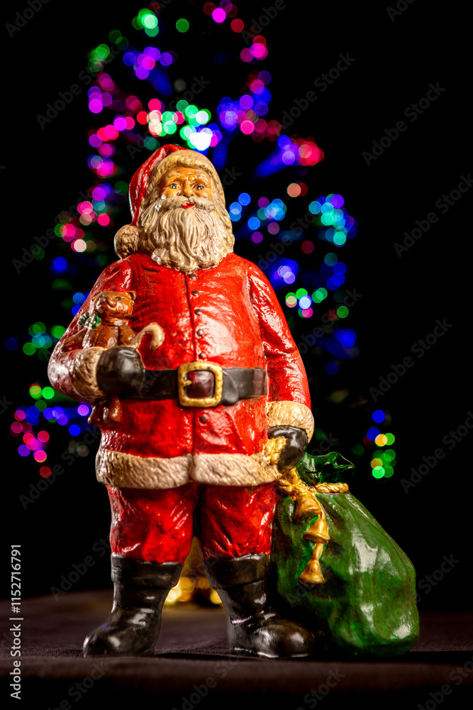This photo features a festive Santa Claus figurine. Santa is depicted wearing his classic red suit with white trim, a black belt with a gold buckle, and black boots. This photo features a festive Santa Claus figurine. Santa is depicted wearing his classic red suit with white trim, a black belt with a gold buckle, and black boots.