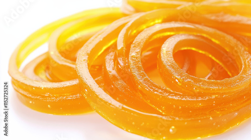 A plate of vibrant, golden-orange seasoned noodles with a spicy glaze, arranged neatly, crisp white background, highlights emphasizing the glossy texture of the noodles, intricate details on the noodl photo