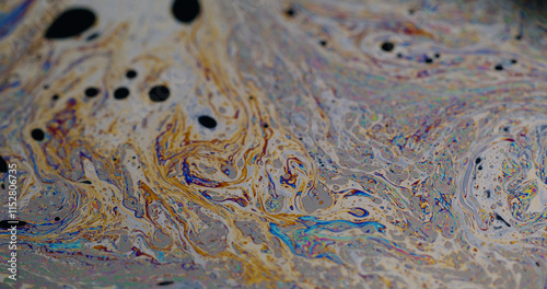 Psychedelic dye. Soap bubbles. Defocused multicolor purple green liquid paint oil rainbow curve acrylic slick on dark black blurred light abstract art background.
