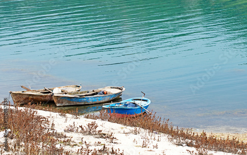 Fishing boats in a coast of Catalan Lake on Seyhan river in Toprakarali in Karaisali distrcit of Adana province in the eastern Mediterranean region of Turkey photo