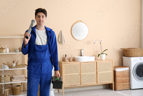 Male plumber with pipe and ...