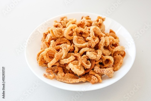 Pork rind, pork cracking,pork snack, in white plate on white background